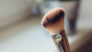 Close up of makeup brush with blurred background