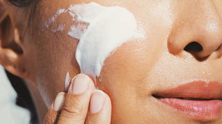 Close up of cream swiped on a woman's cheek