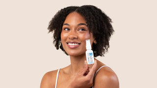 Woman holding CLEARSTEM CELLRENEW Serum