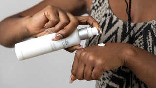 Woman applying Le Mieux moisturizer to hand