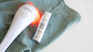 LightStim device and Neogenesis Skin Serum on green cloth