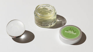 FarmHouse Fresh Watercress Hydration Cascade Retinol Gelee with lid off next to glass sphere