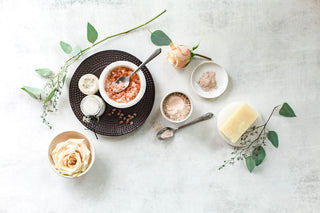 Some roses, salt, and other curios on a stone countertop or table.