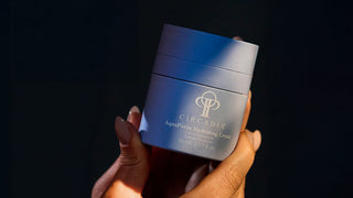 hands holding a jar of Circadia Aquaporin with a dark background