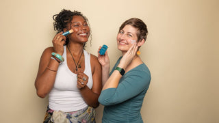 Two women holding Colorescience products up to faces