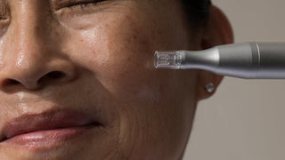 woman with the Art of Skin Care Nano Infusion Pen next to her cheek.