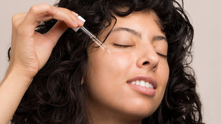 How to use facial oil — woman applying Hale and Hush Remedy Rehab with a dropper to her cheek