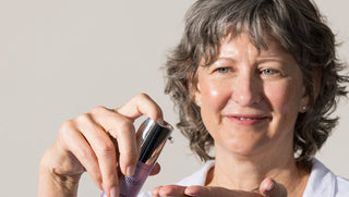 Jeana pumping a serum onto her hand.