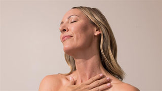 woman with eyes closed and hand on her chest