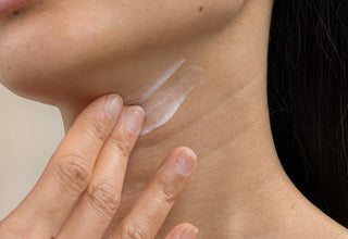 woman applying skinbetter Techno Neck Perfecting Cream