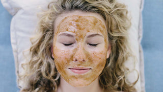 Woman lying down with eyes closed with a sorella pumpkin and papaya face mask on