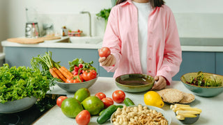 Lettuces, carrots, apple, citrus, avocado on a cutting board