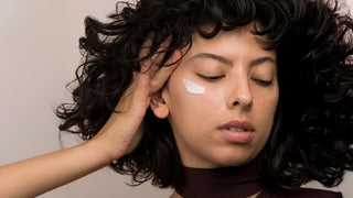 Woman applying eye cream