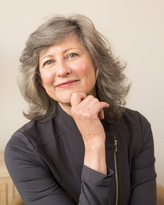 Jeana, founder and licensed esthetician at Art of Skin Care, smiling in a professional portrait.