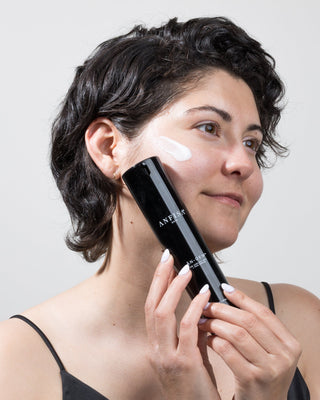 Celine LeClerc applying Anfisa An-Dew to increase brightness and maintain clear skin.