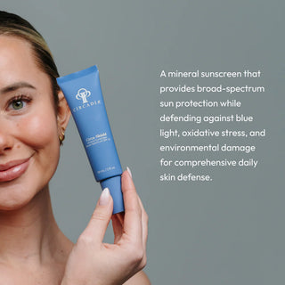 Woman holding Circadia Circa-Shield Mineral Sunscreen SPF 30 blue tube — broad-spectrum mineral sunscreen that defends against UV, blue light, oxidative stress, and environmental damage for daily skin protection
