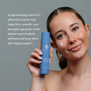 Woman holding Circadia Revita-Cyte Complex Revitalizing Lotion with lotion applied to cheek — rejuvenating vitamin A-alternative lotion that firms, smooths, and energizes aging skin with long-term anti-aging support