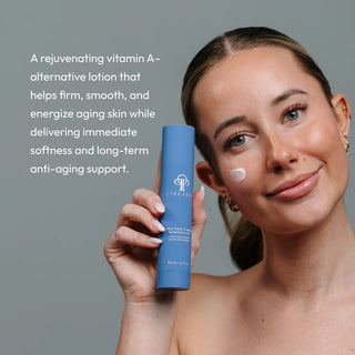 Woman holding Circadia Revita-Cyte Complex Revitalizing Lotion with lotion applied to cheek — rejuvenating vitamin A-alternative lotion that firms, smooths, and energizes aging skin with long-term anti-aging support