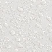 Close-up texture shot of Colorescience Barrier Pro Serum Spray showing lightweight serum droplets on white surface