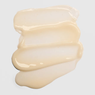 Close-up texture swatch of Colorescience Pep Up Collagen Boost Face and Neck Treatment showing lightweight creamy ivory formula