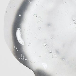 Close-up of Hale & Hush Sensitive Skin Specialist Quiet Wash showing a lightweight clear gel cleanser texture with bubbles on a light gray background