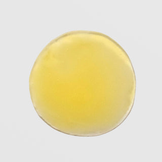 Skin Script Vitamin C Green Tea Serum texture swatch showing smooth golden yellow gel with lightweight fluid consistency. Available at Art of Skin Care