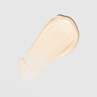 Creamy texture swatch of ALASTIN A-Luminate Brightening Serum on light background