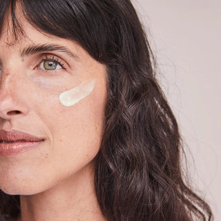 Woman applying ALASTIN Renewal Retinol cream near under-eye area