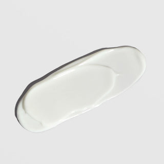 White cream texture swatch of ALASTIN SilkSHIELD Mineral Sunscreen on light background