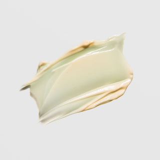 Creamy green-toned texture swatch of ALASTIN TransFORM Body Treatment