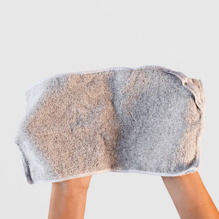 Art of Skincare Luxe Cloth XL grey microfibre cleansing cloth draped over two hands showing size and texture