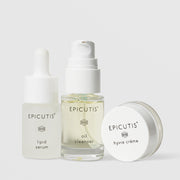 Epicutis Recovery Care Set travel-size trio featuring Lipid Serum frosted dropper bottle, Oil Cleanser clear glass pump bottle, and Hyvia Crème small glass jar on a light gray background
