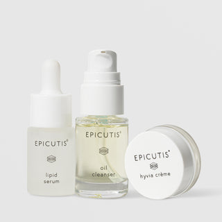 Epicutis Recovery Care Set travel-size trio featuring Lipid Serum frosted dropper bottle, Oil Cleanser clear glass pump bottle, and Hyvia Crème small glass jar on a light gray background