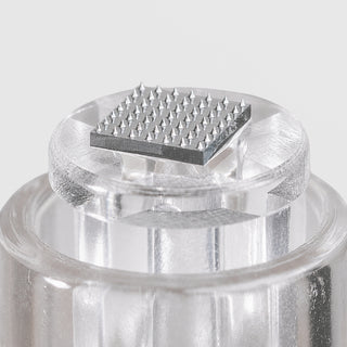 Close-up of Art of Skin Care nano infusion cartridge tip showing precision micro-point needle array on clear cartridge