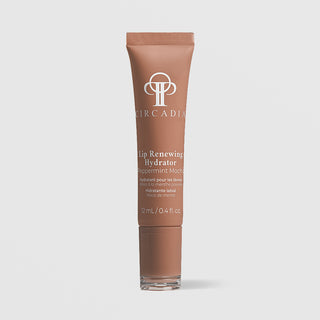 A tube of Circadia Lip Renewing Hydrator peppermint moisturizer in a warm brown shade, shown on a light gray background.