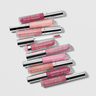 Colorescience Peptide Lip Shine SPF30 full shade range flatlay showing eight lip gloss tubes in pink, nude, berry and mauve shades with silver caps