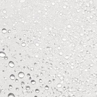 Close-up texture of Colorescience Hydrating Mist Setting Spray showing ultra-fine water droplets on skin.