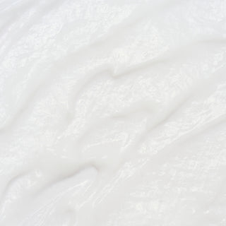 Close-up of Corthe Dermo Essential Rich M Lotion showing a rich, creamy white lotion texture