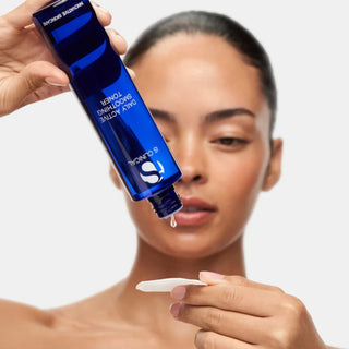 Woman applying iS Clinical Daily Active Smoothing Toner to a cotton pad