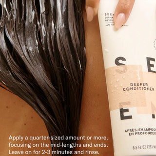 Overhead view of a person applying SEEN Deeper Conditioner to long dark wet hair in the shower, with the product tube visible and the instruction to apply a quarter-sized amount or more to mid-lengths and ends, leave on for 2–3 minutes, then rinse.
