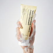 Dermathod Moist Morning Touch Cleanser tube with foamy bubbles in a hand
