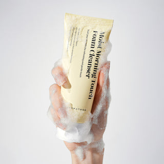 Dermathod Moist Morning Touch Cleanser tube with foamy bubbles in a hand