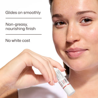 Woman holding EltaMD UV Daily Peptide Lip Balm SPF 40, non-greasy nourishing finish with no white cast