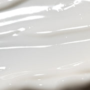 Close-up of Epicutis Arctigenin Brightening Treatment showing a smooth, glossy white cream texture on a light gray background