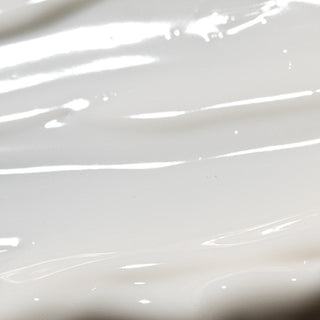 Close-up of Epicutis Arctigenin Brightening Treatment showing a smooth, glossy white cream texture on a light gray background