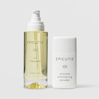 Epicutis Cleansing Essentials Set featuring Oil Cleanser in hinoki wood scent in a clear glass pump bottle and Enzyme Exfoliating Powder in a white bottle, on a light gray background