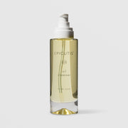 Epicutis Oil Cleanser hinoki wood scent in a clear glass pump bottle with golden-toned oil visible inside, on a light gray background