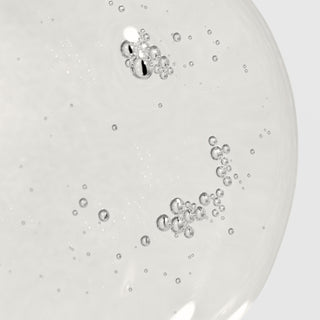 Close-up of Epicutis Oil Cleanser showing a lightweight clear oil texture with delicate bubbles on a light gray background