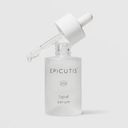 Epicutis Lipid Serum in a frosted glass bottle with dropper resting open at an angle on a light gray background