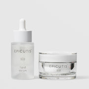 Epicutis Lipid Serum dropper bottle and Hyvia Crème closed glass jar luxury skincare set, on a light gray background